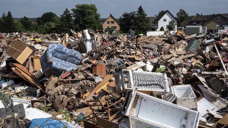 Helpers check for victims in flooded cars on a road in Erftstadt, Germany, Saturday, July 17, 2021. Due to strong rainfall,  the small Erft river went over its banks,  causing massive damage. (AP Photo/Michael Probst)