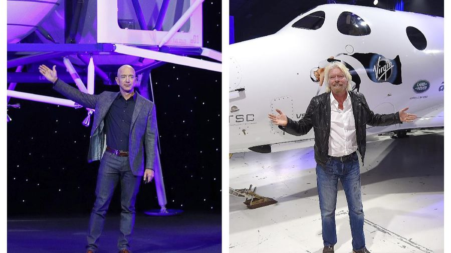 FILE - In this Thursday, May 9, 2019 file phto, Jeff Bezos speaks in front of a model of Blue Origin's Blue Moon lunar lander in Washington. In 2020, NASA Administrator Jim Bridenstine said space is currently a $400 billion market, including satellites. Opening up spaceflight to paying customers, he said, could expand the market to $1 trillion. (AP Photo/Patrick Semansky)