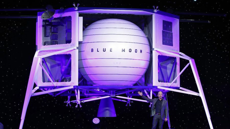 FILE - In this Thursday, May 9, 2019 file phto, Jeff Bezos speaks in front of a model of Blue Origin's Blue Moon lunar lander in Washington. In 2020, NASA Administrator Jim Bridenstine said space is currently a $400 billion market, including satellites. Opening up spaceflight to paying customers, he said, could expand the market to $1 trillion. (AP Photo/Patrick Semansky)