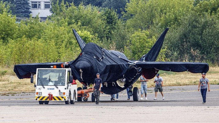 Hidden under tarpaulin, a prospective Russian fighter jet is being towed to a parking spot before its presentation at the Moscow international air show in Zhukovsky outside Moscow, Russia, Thursday, July 15, 2021. Russian aircraft makers say they will present a prospective new fighter jet at a Moscow air show that opens next week. The new warplane hidden under tarpaulin was photographed being towed to a parking spot across the airfield in Zhukovsky outside Moscow. That's where MAKS-2021 International Aviation and Space Salon opens on Tuesday. Russian President Vladimir Putin is set to visit the show’s opening. (AP Photo/Ivan Novikov-Dvinsky)