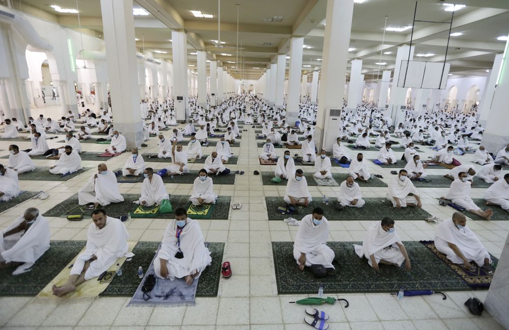 Muslim pilgrims practice social distancing as they pray at the Namira Mosque in Arafat during the annual hajj pilgrimage, near the holy city of Mecca, Saudi Arabia, Monday, July 19, 2021. Tens of thousands of vaccinated Muslim pilgrims circled Islam's holiest site in Mecca on Sunday, but remained socially distanced and wore masks as the coronavirus takes its toll on the hajj for a second year running. What once drew some 2.5 million Muslims from all walks of life from across the globe, the hajj pilgrimage is now almost unrecognizable in scale. (AP Photo/Amr Nabil)