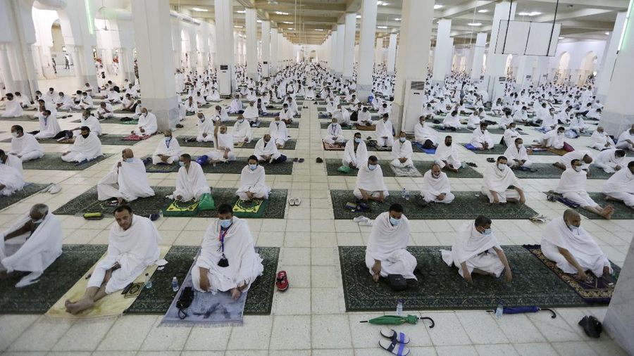 Muslim pilgrims practice social distancing as they pray at the Namira Mosque in Arafat during the annual hajj pilgrimage, near the holy city of Mecca, Saudi Arabia, Monday, July 19, 2021. Tens of thousands of vaccinated Muslim pilgrims circled Islam's holiest site in Mecca on Sunday, but remained socially distanced and wore masks as the coronavirus takes its toll on the hajj for a second year running. What once drew some 2.5 million Muslims from all walks of life from across the globe, the hajj pilgrimage is now almost unrecognizable in scale. (AP Photo/Amr Nabil)