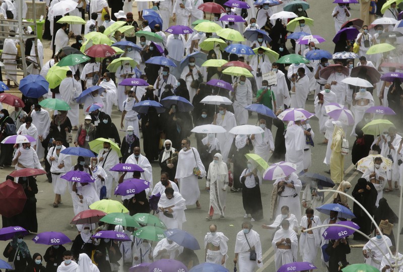 In this photo taken with low shutter speed, Muslim pilgrims circumambulate the Kaaba, the cubic building at the Grand Mosque, at the start the annual hajj pilgrimage, Sunday, July 18, 2021. The pilgrimage to Mecca required once in a lifetime of every Muslim who can afford it and is physically able to make it, used to draw more than 2 million people. But for a second straight year it has been curtailed due to the coronavirus with only vaccinated people in Saudi Arabia able to participate. (AP Photo/Amr Nabil)