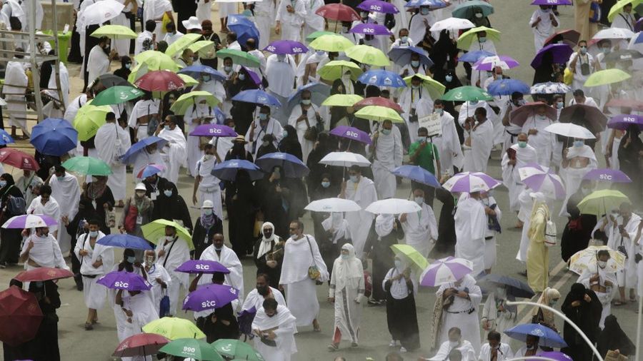 Cooling water sprayers bring down the temperatures as thousands of Muslim pilgrims leave after prayers at the Namira Mosque in Arafat, during the annual hajj pilgrimage, near the holy city of Mecca, Saudi Arabia, Monday, July 19, 2021. The coronavirus has taken its toll on the hajj for a second year running. What once drew some 2.5 million Muslims from all walks of life from across the globe, the hajj pilgrimage is now almost unrecognizable in scale. (AP Photo/Amr Nabil)