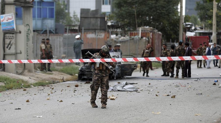 Security personnel inspect a damaged vehicle where rockets were fired from in Kabul, Afghanistan, Tuesday, July 20, 2021. At least three rockets hit near the presidential palace on Tuesday shortly before Afghan President Ashraf Ghani was to give an address to mark the Muslim holiday of Eid-al-Adha. (AP Photo/Rahmat Gul)