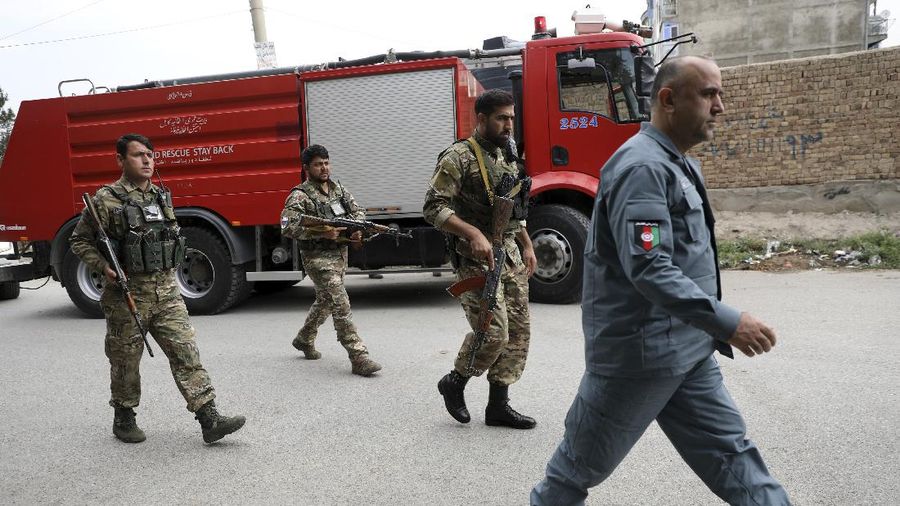Security personnel inspect a damaged vehicle where rockets were fired from in Kabul, Afghanistan, Tuesday, July 20, 2021. At least three rockets hit near the presidential palace on Tuesday shortly before Afghan President Ashraf Ghani was to give an address to mark the Muslim holiday of Eid-al-Adha. (AP Photo/Rahmat Gul)