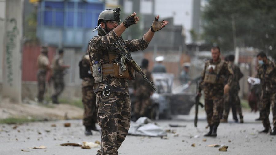 Security personnel inspect a damaged vehicle where rockets were fired from in Kabul, Afghanistan, Tuesday, July 20, 2021. At least three rockets hit near the presidential palace on Tuesday shortly before Afghan President Ashraf Ghani was to give an address to mark the Muslim holiday of Eid-al-Adha. (AP Photo/Rahmat Gul)