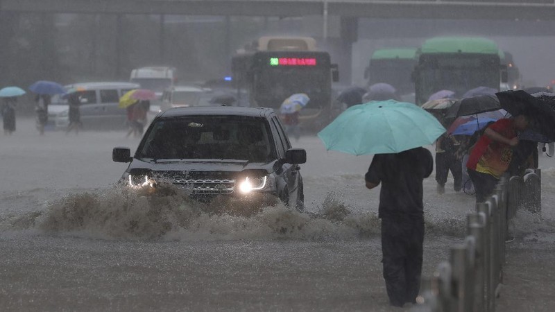 Vehicles are stranded after a heavy downpour in Zhengzhou city, central China's Henan province on Tuesday, July 20, 2021. Heavy flooding has hit central China following unusually heavy rains, with the subway system in the city of Zhengzhou inundated with rushing water. (Chinatopix Via AP)
