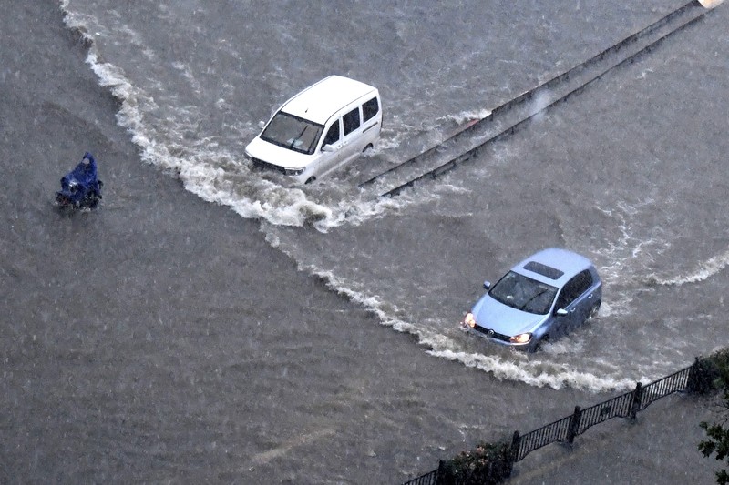 Vehicles are stranded after a heavy downpour in Zhengzhou city, central China's Henan province on Tuesday, July 20, 2021. Heavy flooding has hit central China following unusually heavy rains, with the subway system in the city of Zhengzhou inundated with rushing water. (Chinatopix Via AP)