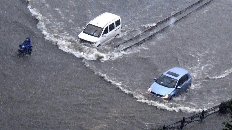 Vehicles are stranded after a heavy downpour in Zhengzhou city, central China's Henan province on Tuesday, July 20, 2021. Heavy flooding has hit central China following unusually heavy rains, with the subway system in the city of Zhengzhou inundated with rushing water. (Chinatopix Via AP)