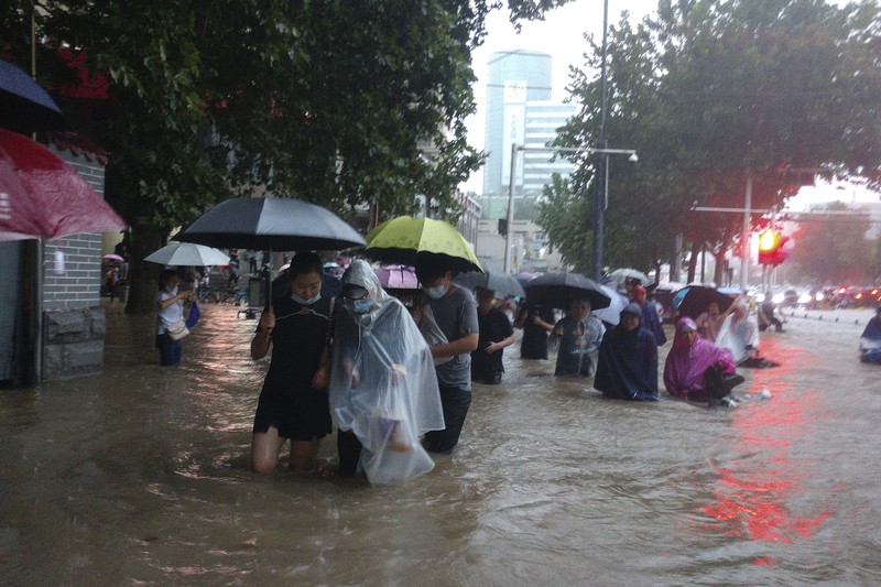 Vehicles are stranded after a heavy downpour in Zhengzhou city, central China's Henan province on Tuesday, July 20, 2021. Heavy flooding has hit central China following unusually heavy rains, with the subway system in the city of Zhengzhou inundated with rushing water. (Chinatopix Via AP)