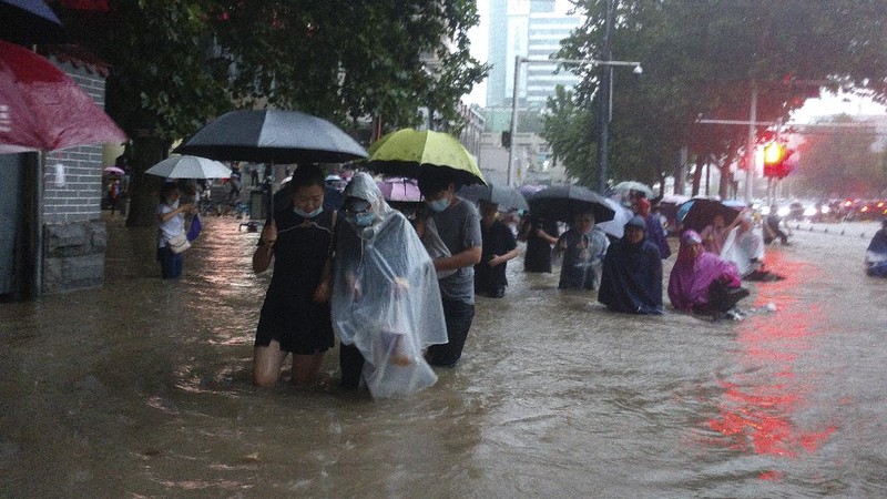 Vehicles are stranded after a heavy downpour in Zhengzhou city, central China's Henan province on Tuesday, July 20, 2021. Heavy flooding has hit central China following unusually heavy rains, with the subway system in the city of Zhengzhou inundated with rushing water. (Chinatopix Via AP)