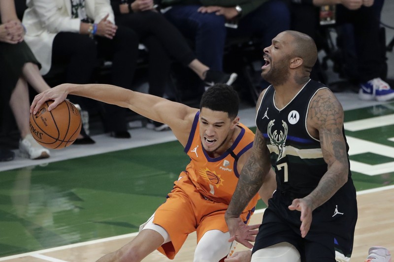 Final NBA Milwaukee Bucks vs Phoenix Suns Phoenix Suns guard Devin Booker (1) works the ball against Milwaukee Bucks guard Bryn Forbes (7) during the first half of Game 6 of basketball's NBA Finals Tuesday, July 20, 2021, in Milwaukee. (AP Photo/Aaron Gash)