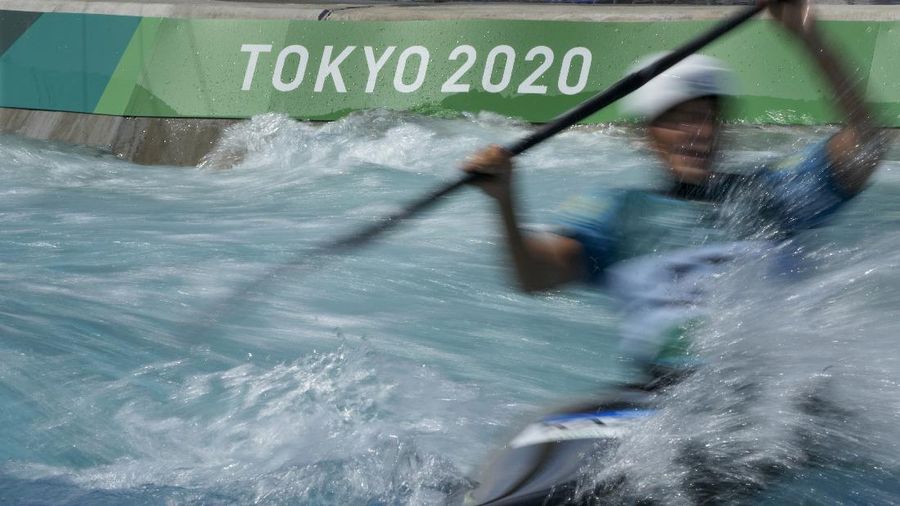 Lightning illuminates the sky over the Olympic rings and the Rainbow Bridge in Tokyo, Sunday, July 11, 2021. The opening ceremony of the postponed 2020 Summer Olympics is scheduled to be held in less than two weeks. (Kyodo News via AP)