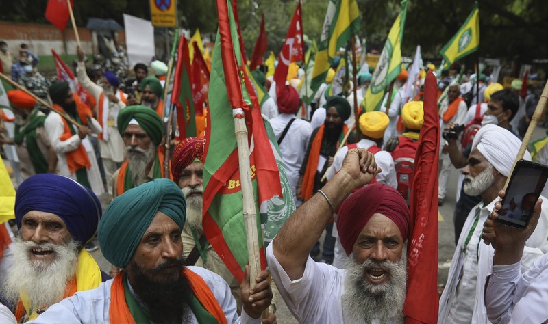Farmers shout anti government slogans during a protest in New Delhi, India, Thursday, July 22, 2021. More than 200 farmers on Thursday began a protest near India's Parliament to mark eight months of their agitation against new agricultural laws that they say will devastate their income. (AP Photo/Manish Swarup)