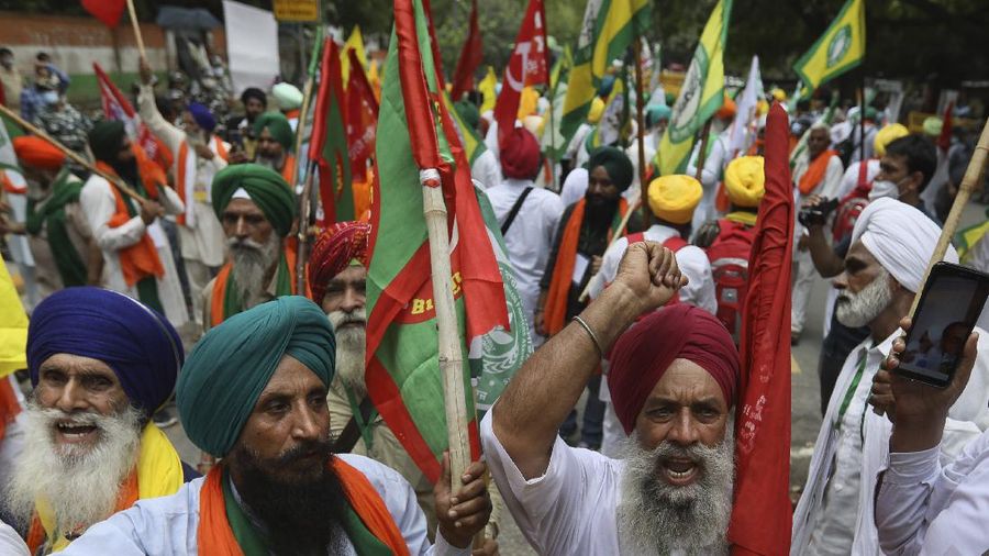 Farmers shout anti government slogans during a protest in New Delhi, India, Thursday, July 22, 2021. More than 200 farmers on Thursday began a protest near India's Parliament to mark eight months of their agitation against new agricultural laws that they say will devastate their income. (AP Photo/Manish Swarup)