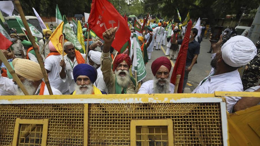 Farmers shout anti government slogans during a protest in New Delhi, India, Thursday, July 22, 2021. More than 200 farmers on Thursday began a protest near India's Parliament to mark eight months of their agitation against new agricultural laws that they say will devastate their income. (AP Photo/Manish Swarup)