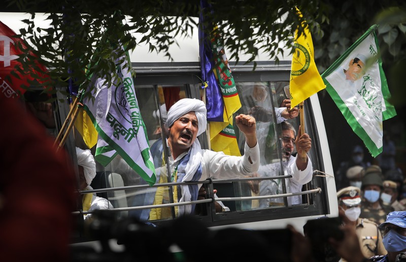 Farmers shout anti government slogans during a protest in New Delhi, India, Thursday, July 22, 2021. More than 200 farmers on Thursday began a protest near India's Parliament to mark eight months of their agitation against new agricultural laws that they say will devastate their income. (AP Photo/Manish Swarup)