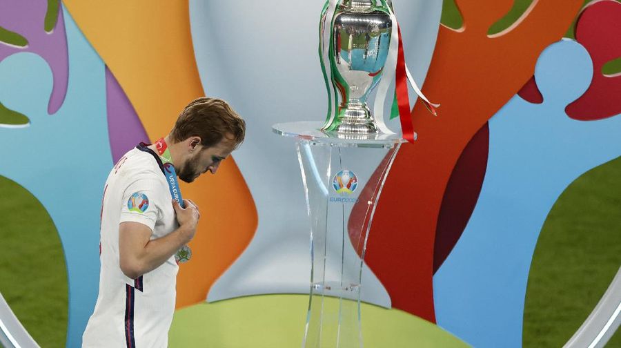 England's Harry Kane walks past the trophy after receiving his runner-up medal following their loss to Italy in the Euro 2020 soccer championship final at Wembley stadium in London, Sunday, July 11, 2021. (John Sibley/Pool Photo via AP)