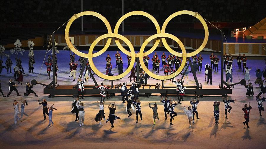 Dancers perform in front of the Olympic rings during the opening ceremony in the Olympic Stadium at the 2020 Summer Olympics, Friday, July 23, 2021, in Tokyo, Japan. (Dylan Martinez/Pool Photo via AP)