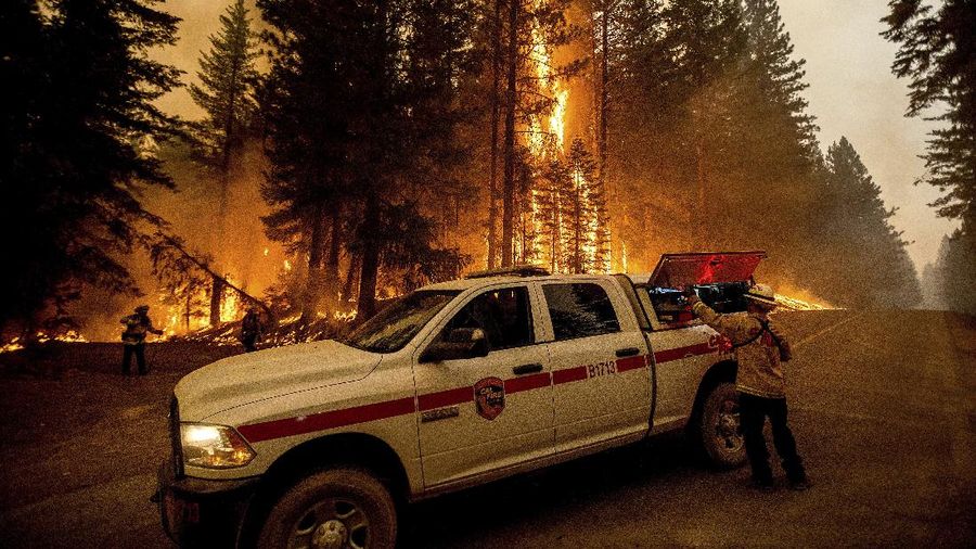 Flames consume vehicles as the Dixie Fire tears through the Indian Falls community in Plumas County, Calif., Saturday, July 24, 2021. The fire destroyed multiple residences in the area. (AP Photo/Noah Berger)