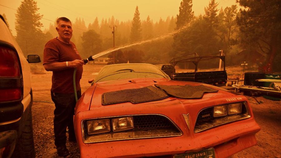 Flames consume vehicles as the Dixie Fire tears through the Indian Falls community in Plumas County, Calif., Saturday, July 24, 2021. The fire destroyed multiple residences in the area. (AP Photo/Noah Berger)