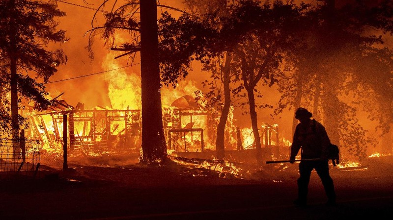 Flames consume vehicles as the Dixie Fire tears through the Indian Falls community in Plumas County, Calif., Saturday, July 24, 2021. The fire destroyed multiple residences in the area. (AP Photo/Noah Berger)