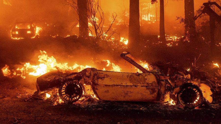 Flames consume vehicles as the Dixie Fire tears through the Indian Falls community in Plumas County, Calif., Saturday, July 24, 2021. The fire destroyed multiple residences in the area. (AP Photo/Noah Berger)