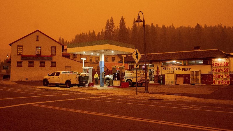 Flames consume vehicles as the Dixie Fire tears through the Indian Falls community in Plumas County, Calif., Saturday, July 24, 2021. The fire destroyed multiple residences in the area. (AP Photo/Noah Berger)