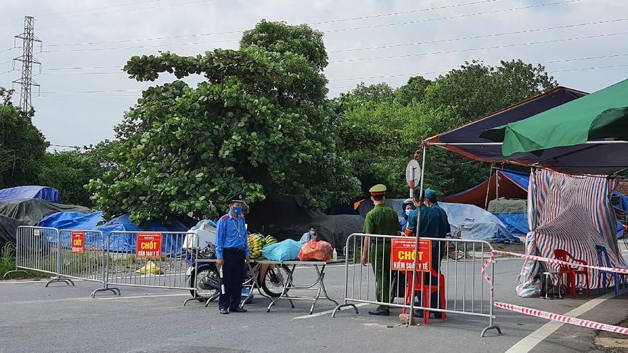 People are turned away at a checkpoint at an entrance to Hanoi, Vietnam, Saturday, July 24, 2021. Vietnam announced a 15-day lockdown in the capital Hanoi starting Saturday as a coronavirus surge spread from the southern Mekong Delta region. (AP Photo/Hieu Dinh)