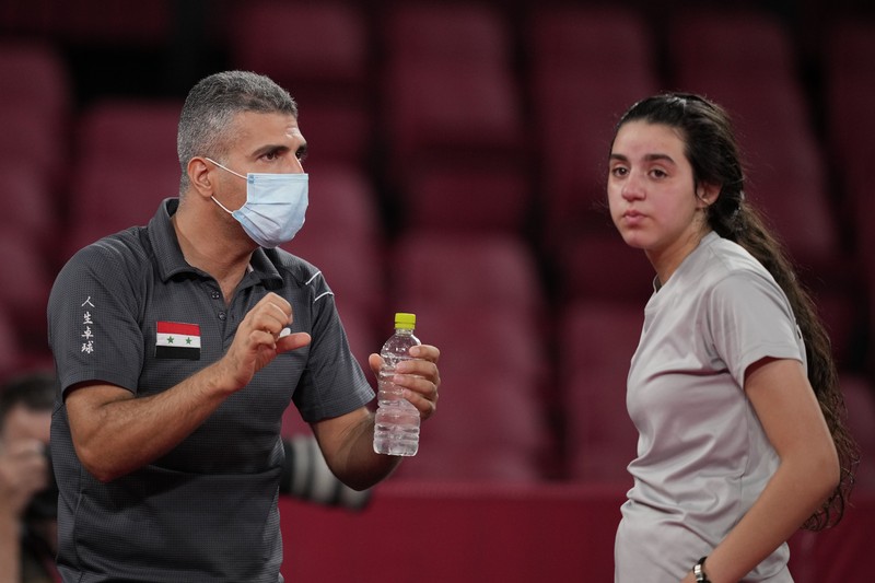 Syria's Hend Zaza competes during women's table tennis singles preliminary round match against Austria's Liu Jia at the 2020 Summer Olympics, Saturday, July 24, 2021, in Tokyo. (AP Photo/Kin Cheung)