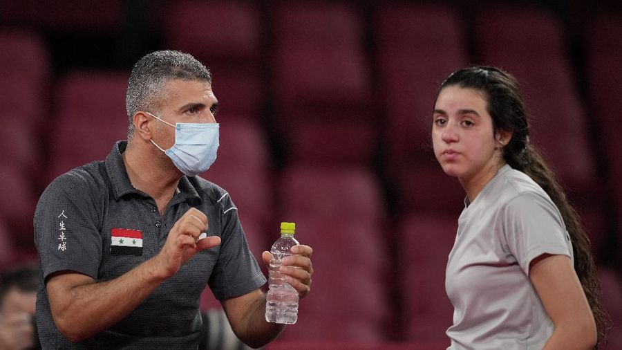 Syria's Hend Zaza competes during women's table tennis singles preliminary round match against Austria's Liu Jia at the 2020 Summer Olympics, Saturday, July 24, 2021, in Tokyo. (AP Photo/Kin Cheung)