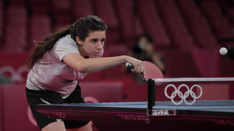 Syria's Hend Zaza competes during women's table tennis singles preliminary round match against Austria's Liu Jia at the 2020 Summer Olympics, Saturday, July 24, 2021, in Tokyo. (AP Photo/Kin Cheung)