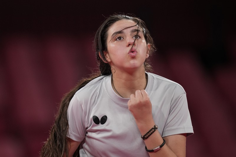 Syria's Hend Zaza competes during women's table tennis singles preliminary round match against Austria's Liu Jia at the 2020 Summer Olympics, Saturday, July 24, 2021, in Tokyo. (AP Photo/Kin Cheung)