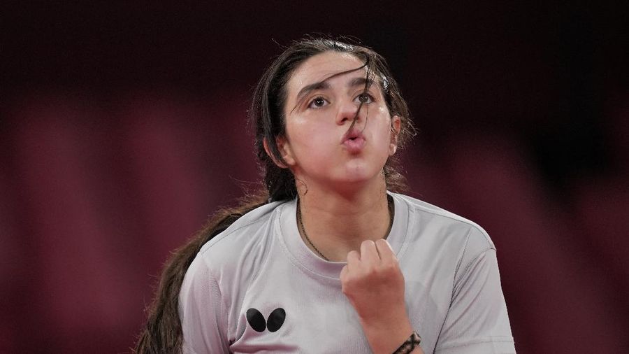 Syria's Hend Zaza competes during women's table tennis singles preliminary round match against Austria's Liu Jia at the 2020 Summer Olympics, Saturday, July 24, 2021, in Tokyo. (AP Photo/Kin Cheung)