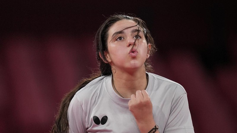 Syria's Hend Zaza competes during women's table tennis singles preliminary round match against Austria's Liu Jia at the 2020 Summer Olympics, Saturday, July 24, 2021, in Tokyo. (AP Photo/Kin Cheung)