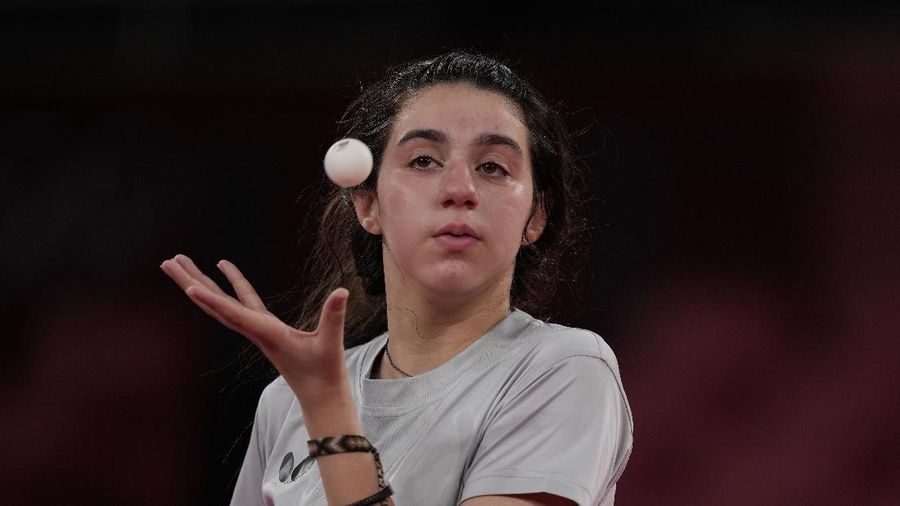 Syria's Hend Zaza competes during women's table tennis singles preliminary round match against Austria's Liu Jia at the 2020 Summer Olympics, Saturday, July 24, 2021, in Tokyo. (AP Photo/Kin Cheung)