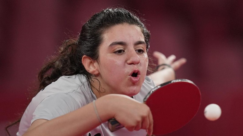 Syria's Hend Zaza competes during women's table tennis singles preliminary round match against Austria's Liu Jia at the 2020 Summer Olympics, Saturday, July 24, 2021, in Tokyo. (AP Photo/Kin Cheung)