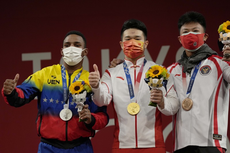 Rahmat Erwin Abdullah Rhamat Erwin Abdullah of Indonesia competes in the men's 73kg weightlifting event, at the 2020 Summer Olympics, Wednesday, July 28, 2021, in Tokyo, Japan. (AP Photo/Luca Bruno)