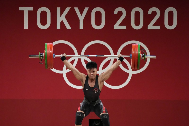 Rahmat Erwin Abdullah Rhamat Erwin Abdullah of Indonesia competes in the men's 73kg weightlifting event, at the 2020 Summer Olympics, Wednesday, July 28, 2021, in Tokyo, Japan. (AP Photo/Luca Bruno)