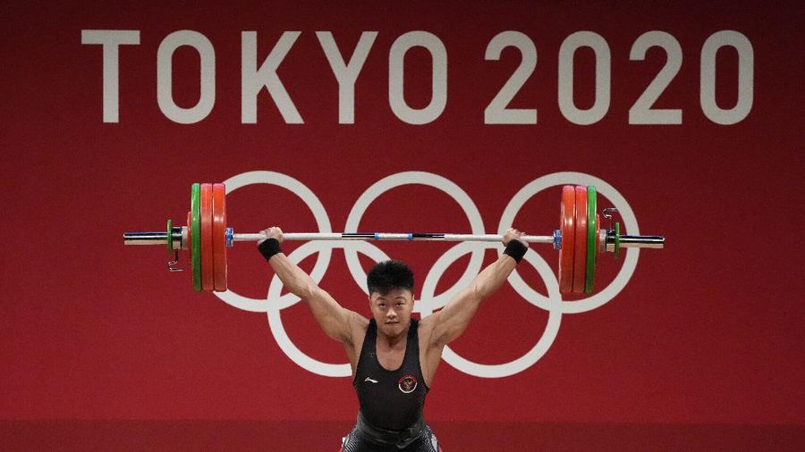 Rhamat Erwin Abdullah of Indonesia competes in the men's 73kg weightlifting event, at the 2020 Summer Olympics, Wednesday, July 28, 2021, in Tokyo, Japan. (AP Photo/Luca Bruno)