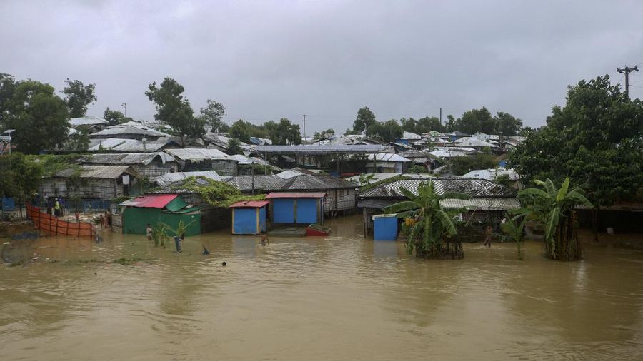 A view of inundated shelters following heavy rains at the Rohingya refugee camp in Kutupalong, Bangladesh, Wednesday, July 28, 2021. Days of heavy rains have brought thousands of shelters in various Rohingya refugee camps in Southern Bangladesh under water, rendering thousands of refugees homeless. (AP Photo/ Shafiqur Rahman)