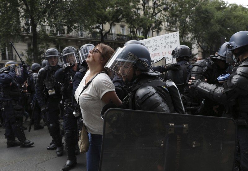 Protestors march waving French flags during a demonstration in Paris, France, Saturday, July 31, 2021. Demonstrators gathered in several cities in France on Saturday to protest against the COVID-19 pass, which grants vaccinated individuals greater ease of access to venues. (AP Photo/Adrienne Surprenant)