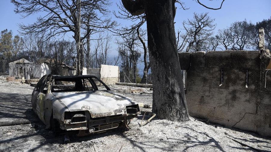 An aerial photo shows destroyed houses in a village as wildfires continue to rage the forests near the Mediterranean coastal town of Manavgat, Antalya, Turkey, Thursday, July 29, 2021. Authorities evacuated homes in southern Turkey as a wildfire fanned by strong winds raged through a forest area near the Mediterranean coastal town of Manavgat. District governor Mustafa Yigit said residents of four neighborhoods were moved out of the fire's path as firefighters worked to control the blaze that broke out Wednesday. It was not immediately clear what caused the fire but authorities said nearby tourist resorts were not affected. (Suat Metin/IHA via AP)