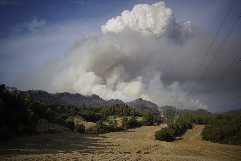 An aerial photo shows destroyed houses in a village as wildfires continue to rage the forests near the Mediterranean coastal town of Manavgat, Antalya, Turkey, Thursday, July 29, 2021. Authorities evacuated homes in southern Turkey as a wildfire fanned by strong winds raged through a forest area near the Mediterranean coastal town of Manavgat. District governor Mustafa Yigit said residents of four neighborhoods were moved out of the fire's path as firefighters worked to control the blaze that broke out Wednesday. It was not immediately clear what caused the fire but authorities said nearby tourist resorts were not affected. (Suat Metin/IHA via AP)