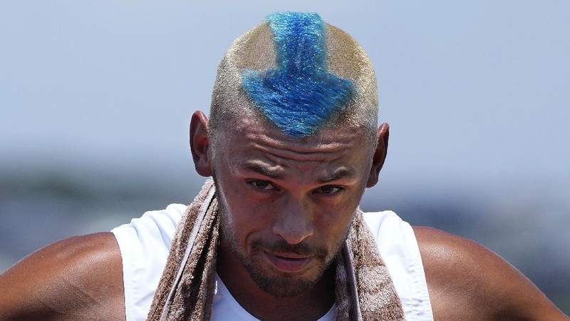Mongolian coach Undralbat Lkhagva has the Olympic rings cut and dyed into his hair as he watches the women's 10-meter air pistol at the Asaka Shooting Range in the 2020 Summer Olympics, Sunday, July 25, 2021, in Tokyo, Japan. (AP Photo/Alex Brandon)