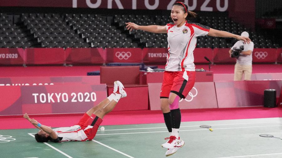 Indonesia's Greysia Polii, left, and Apriyani Rahayu celebrates after making a point during their women's doubles gold medal match against China's Chen Qing Chen and Jia Yi Fan at the 2020 Summer Olympics, Monday, Aug. 2, 2021, in Tokyo, Japan. (AP Photo/Markus Schreiber)