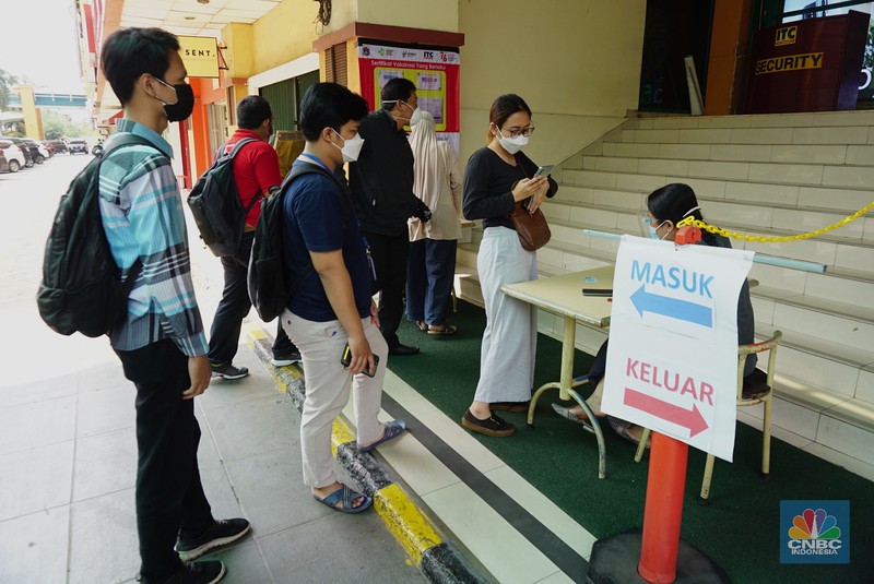 Petugas mengecek kartu vaksin pengunjung yang akan masuk kedalam mal ITC Fatmawati, Selasa (3/8/2021). Pengelola pusat perbelanjaan mendukung rencana masuk mal harus menunjukkan setifikat vaksin, hal ini dinilai dapat mempercepat program vaksinasi Covid-19 dan untuk mencapai kekebalan kelompok (herd immunity). (CNBC Indonesia/Tri Susilo)