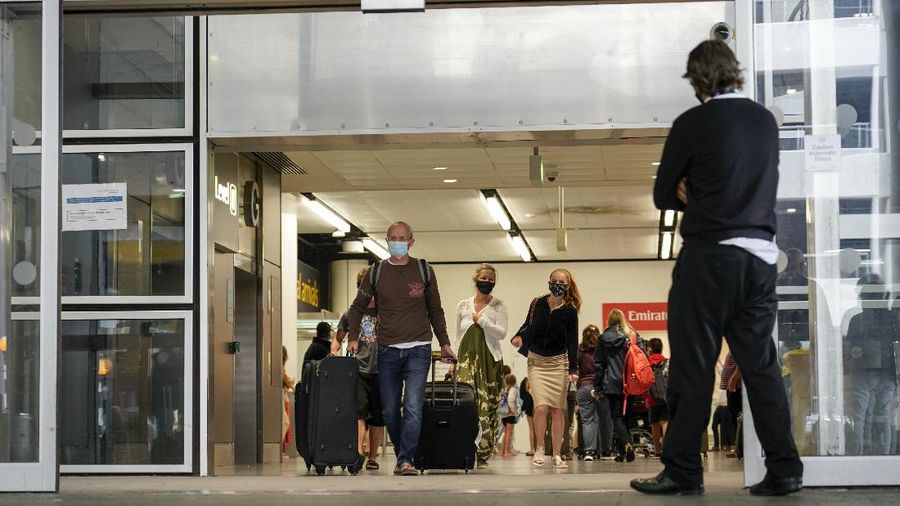 An indication sign at Gatwick Airport, in London, Monday, Aug. 2, 2021. Travelers fully vaccinated against coronavirus from the United States and much of Europe were able to enter Britain without quarantining starting today, a move welcomed by Britain's ailing travel industry.(AP Photo/Alberto Pezzali)