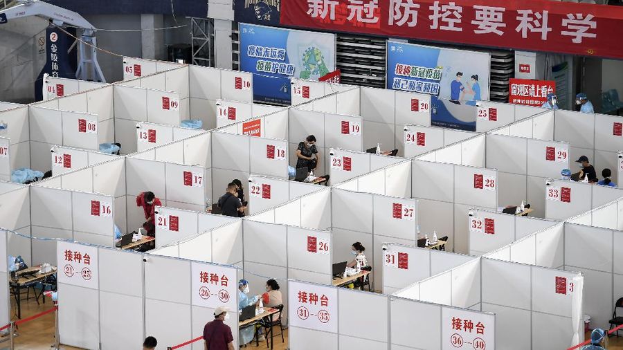 In this photo released by China's Xinhua News Agency, people get COVID-19 vaccinations at a vaccination site at a sports arena in Nanjing in eastern China's Jiangsu Province, Monday, Aug. 2, 2021. Chinese authorities announced Tuesday mass coronavirus testing in Wuhan as an unusually wide series of COVID-19 outbreaks reached the city where the disease was first detected in late 2019. Most of the local cases are still in Jiangsu province, where an outbreak started at the airport in Nanjing, the provincial capital, and has spread to the city of Yangzhou. (Ji Chunpeng/Xinhua via AP)